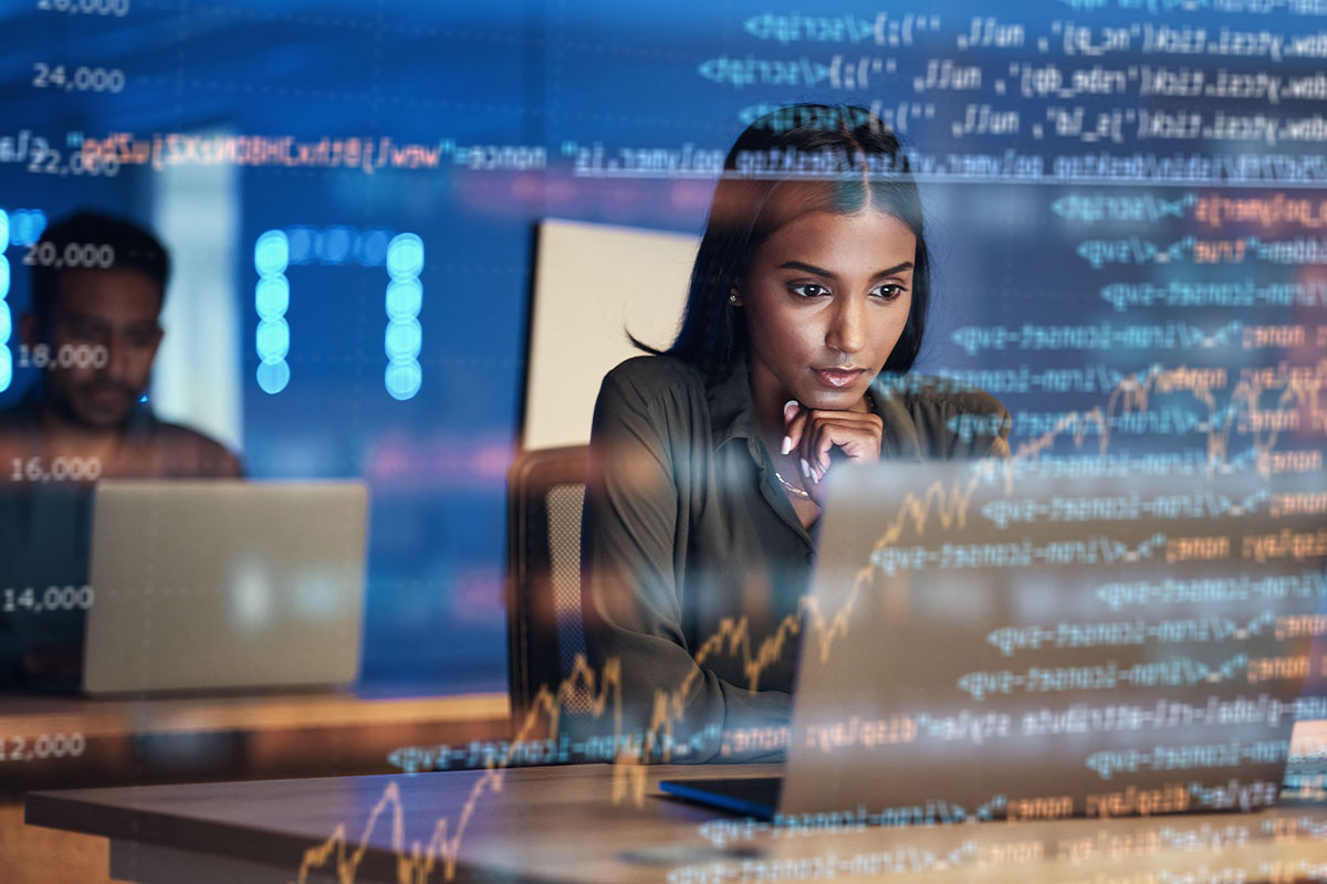 Woman looking at a laptop screen with computer code overlayed in the background.