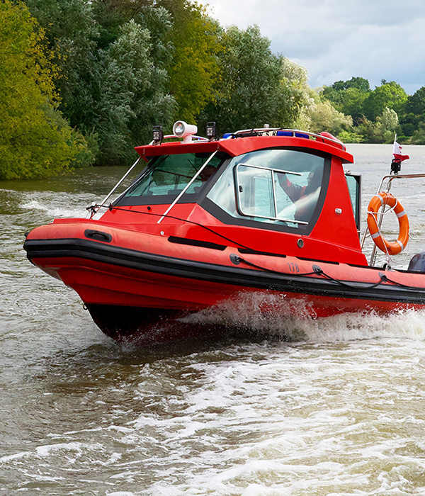 A high horsepower boat travels on on the water carrying emergency medical equipment.